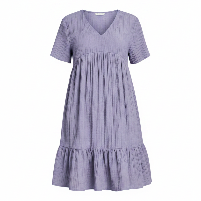 A short-sleeve V-neck babydoll dress in a textured lavender-gray fabric, featuring a gathered waist and a ruffled hem, shown against a plain white background.